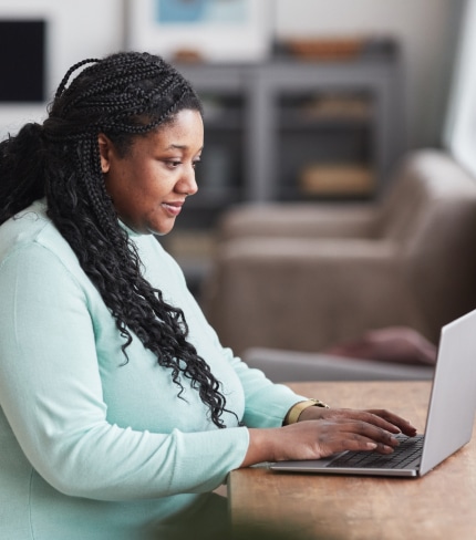 Woman of color on her laptop.